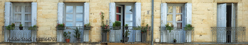 Panorama shot of rustic doors and balconies in France photo