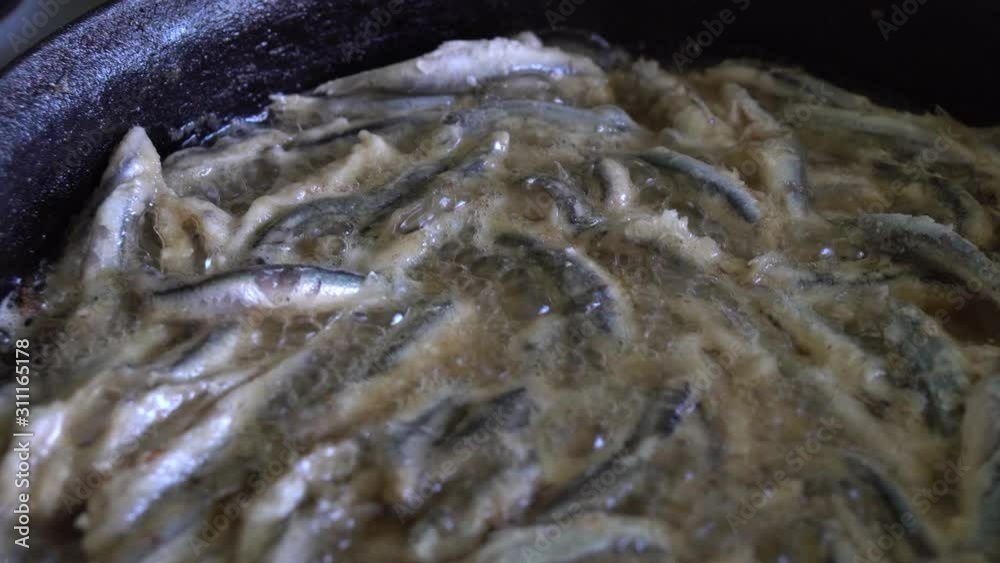 Anchovy frying in hot pan, kitchen Anchovy frying in hot pan, kitchen