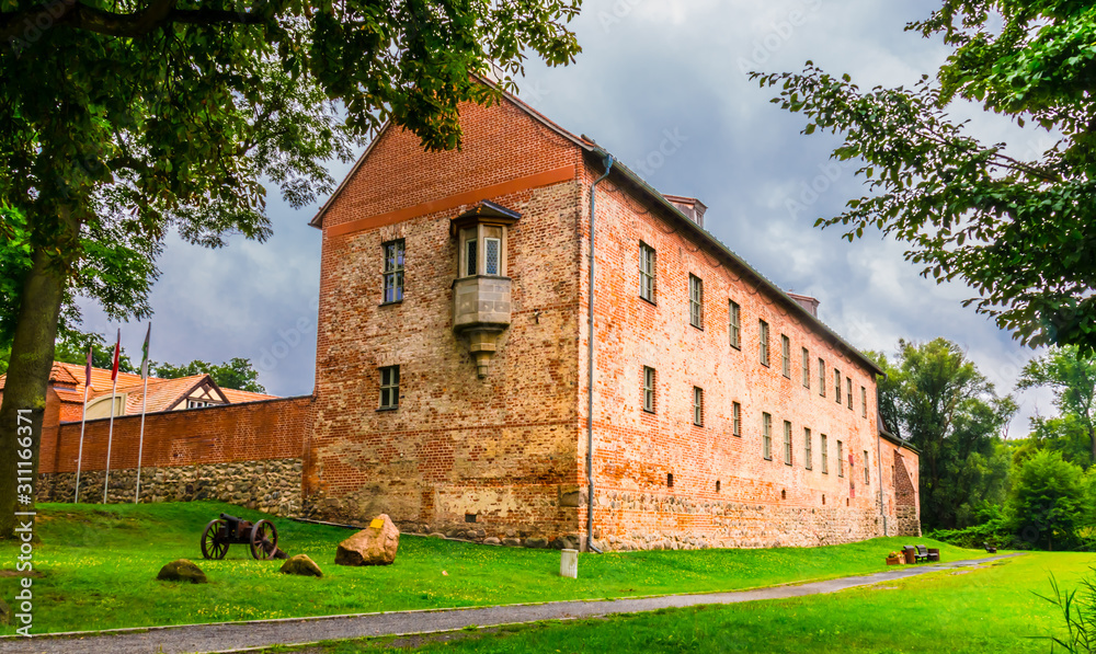 The old castle Storkow in Brandenburg Germany was built in the middle of the 12th century. The west side of the castle with bay window and cannon.