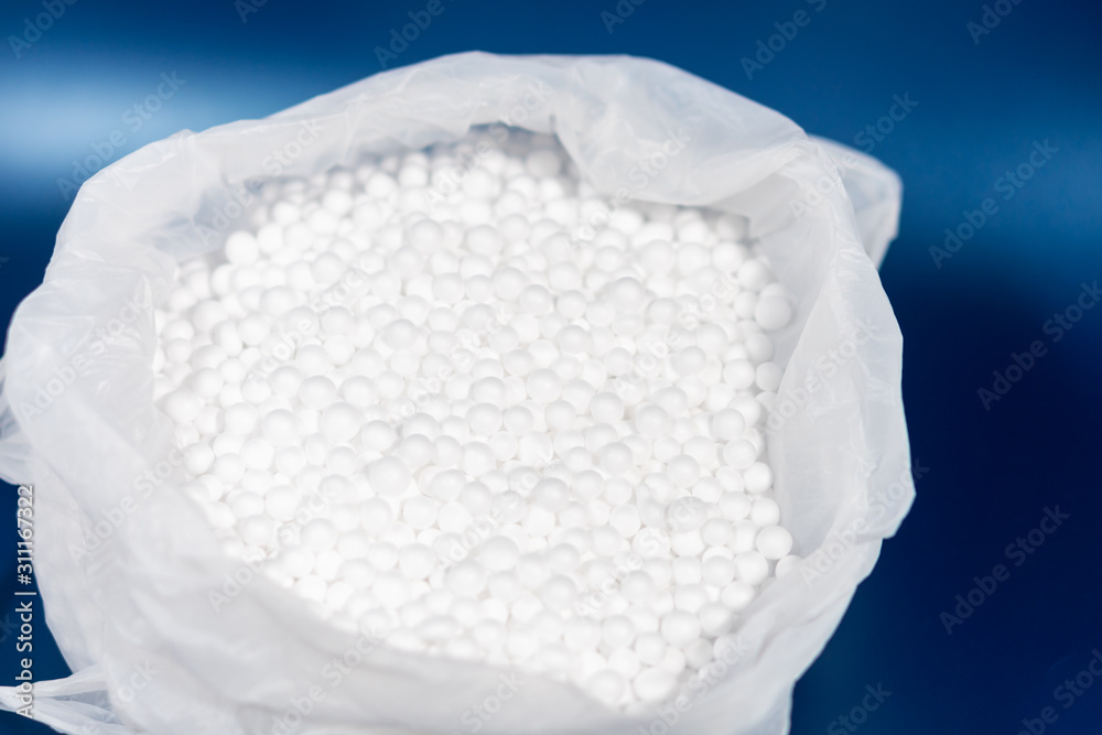 white polystyrene foam beads in plastic bag, non recyclable plastic packaging material environment waste