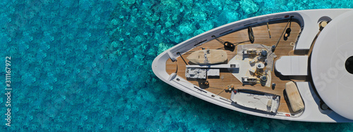 Aerial drone top down ultra wide photo of luxury yacht nose docked in tropical exotic bay © aerial-drone
