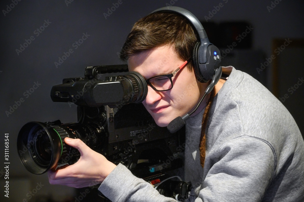 Cameraman using professional digital video camera . Cameraman using professional digital video camera .