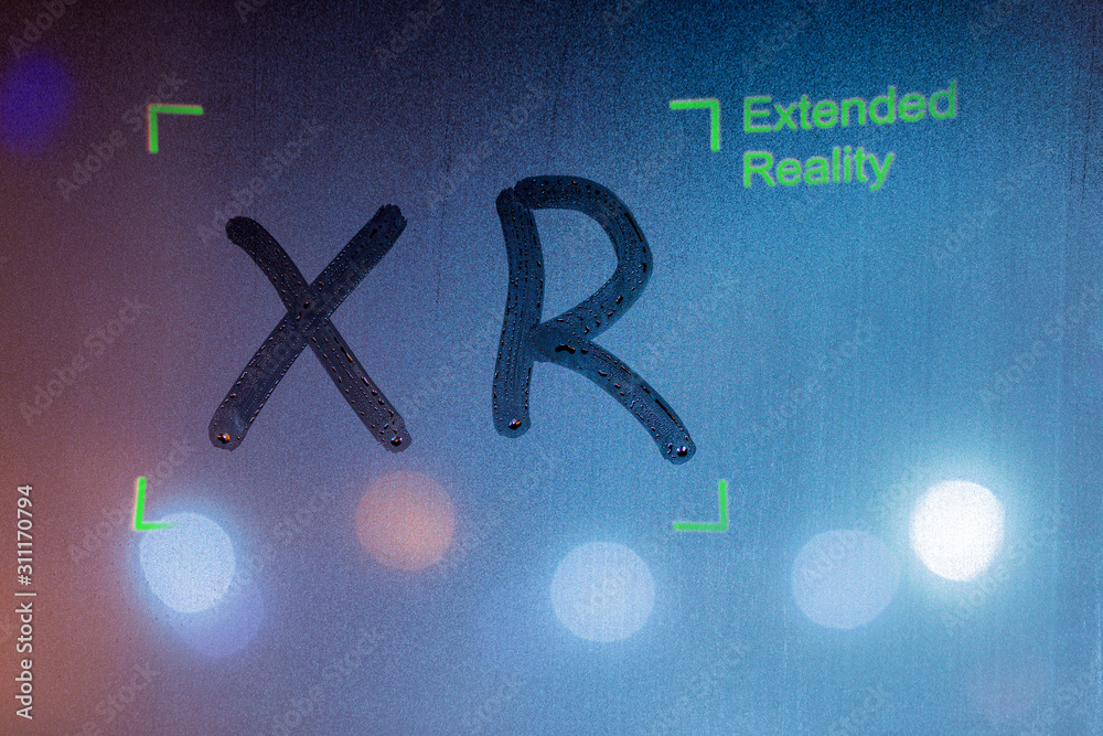 the word xr handwritten by finger on wet window glass with green ...