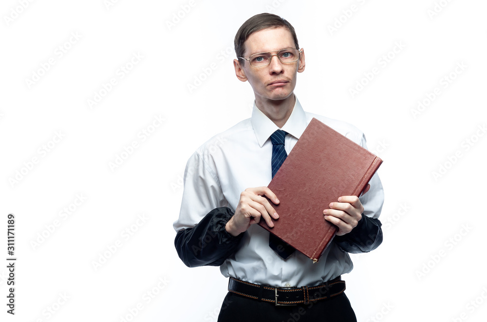 A business man in a tie and glasses with a magazine in his hands on a white, isolated background. A business man in a tie and glasses with a magazine in his hands on a white, isolated background.