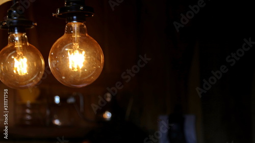 Decor of antique edison backlights against a background of wooden buildings