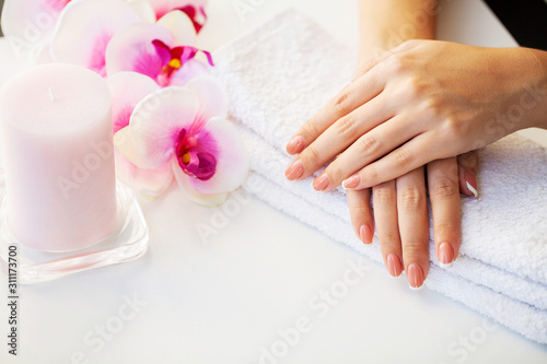 Nails care. Beautiful woman s nails with french manicure  in beauty studio
