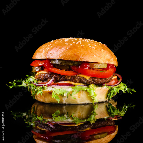 fast food juicy burger on a black background