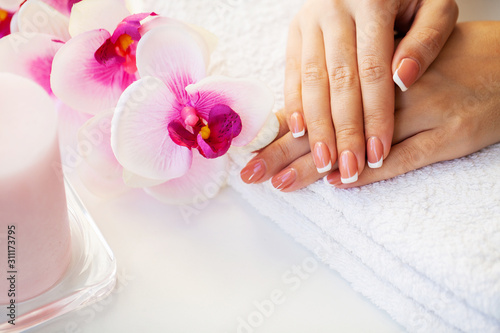 Nails care. Beautiful woman s nails with french manicure  in beauty studio