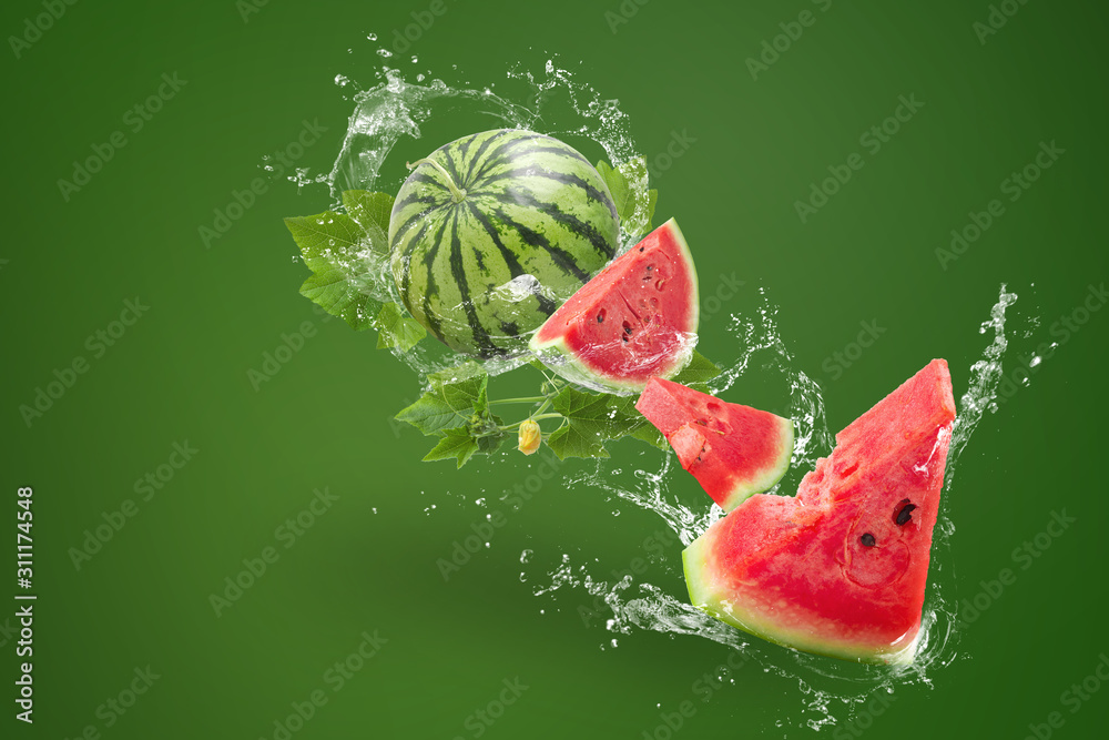 Water splashing on Sliced of watermelon on green background - obrazy, fototapety, plakaty 