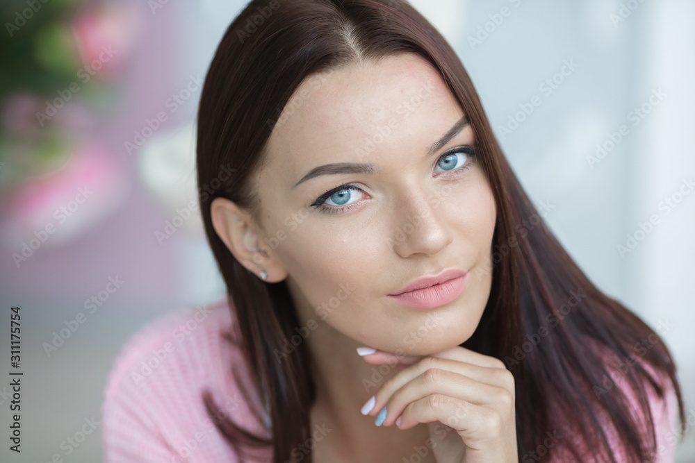 Close-up portrait of an incredibly beautiful woman dressed in pink pajamas. Close-up portrait of an incredibly beautiful woman dressed in pink pajamas.