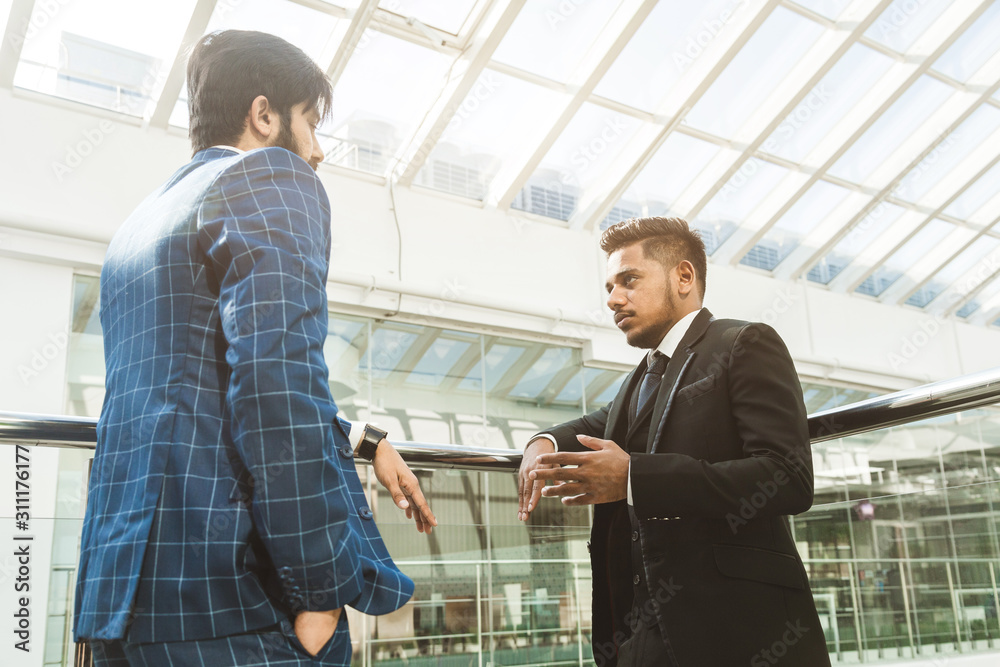 young business people are standing and talking on the background of glass offices. Corporate businessteam and manager in a meeting. young business people are standing and talking on the background of glass offices. Corporate businessteam and manager in a meeting.