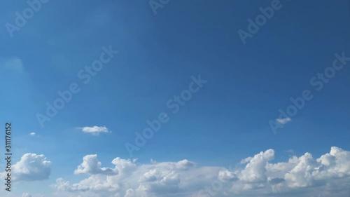 Time lapse, motion fluffy of groups white clouds moving on blue sky background