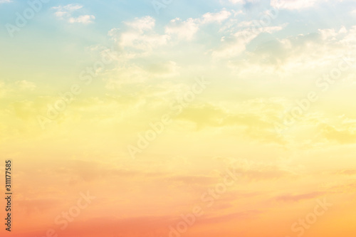A soft fog cloug background with pastel colored orange to blue gradient © Theeranad