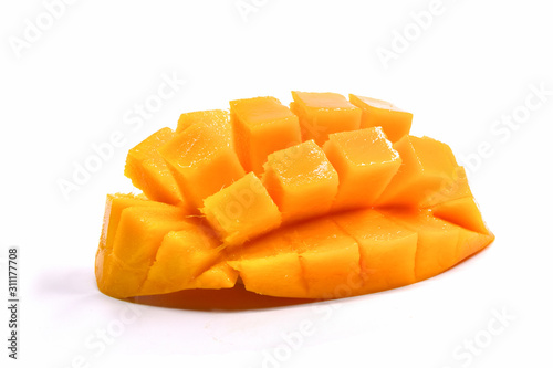 An isolated mango partially sliced into cubes.