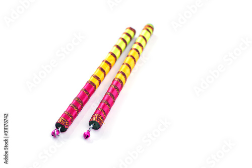 Dandiya sticks on a white background. Raas Garba or Dandiya Raas is the traditional folk dance form the state of Gujarat & Rajasthan in India.