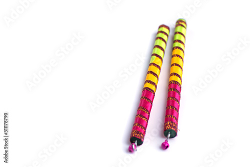 Dandiya sticks on a white background. Raas Garba or Dandiya Raas is the traditional folk dance form the state of Gujarat & Rajasthan in India.