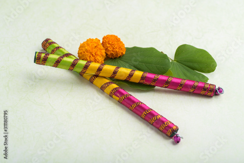 Indian Festival Dussehra, showing golden leaf (Bauhinia racemosa) and marigold flowers with Dandiya sticks.