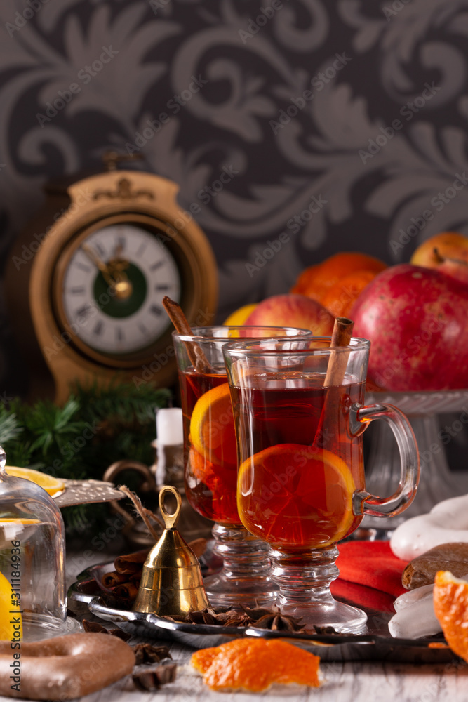 Two glasses with mulled wine on a tray with christmas accessories Two glasses with mulled wine on a tray with christmas accessories