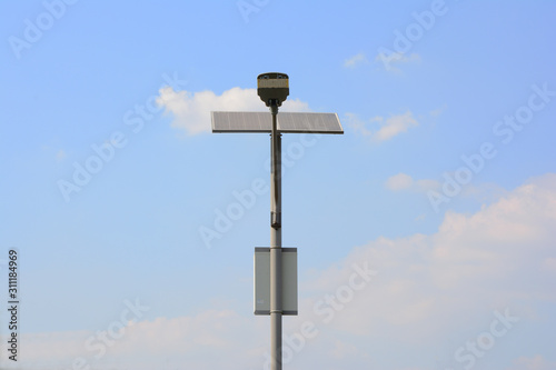 Close up of steel pole with lamps and solar cells With a background sky