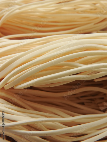 Front view of three layer of raw thin noodles full of frame. Food ingredients. Asian, Taiwanese cuisine ingredients. With copy space. Could be background.