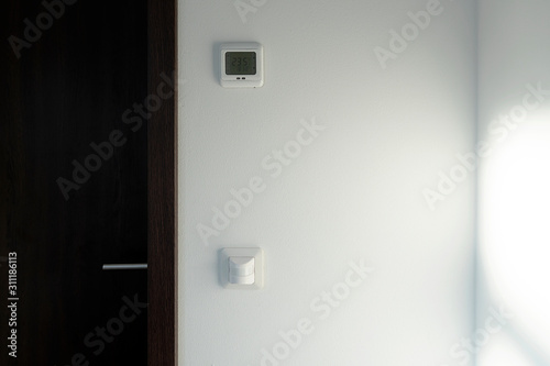 Smart home system. The room has a motion sensor to turn on the light. There is a climate control of the temperature.