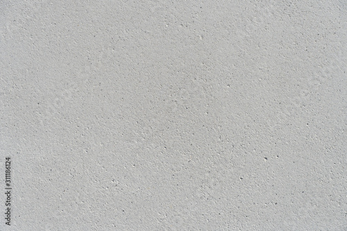 White concrete wall with a flat surface and small pores. Gray surface for design background.