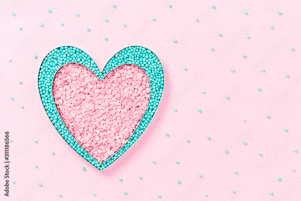 Pink and mint colors cake sprinkles sweets heart shape on pink background with copy space, flat lay. Love, 8 March, Womens Mother's and Valentines Day card concept
