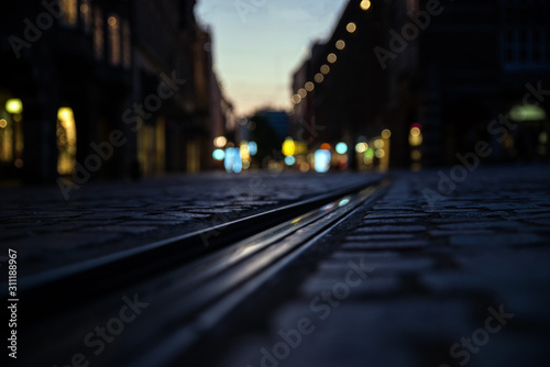 Evening train tracks with blurred background. Tramp trails in the city