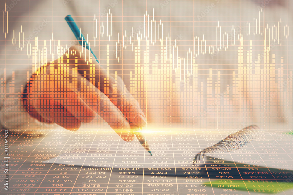 Financial forex graph displayed on hands taking notes background. Concept of research. Double exposure Financial forex graph displayed on hands taking notes background. Concept of research. Double exposure