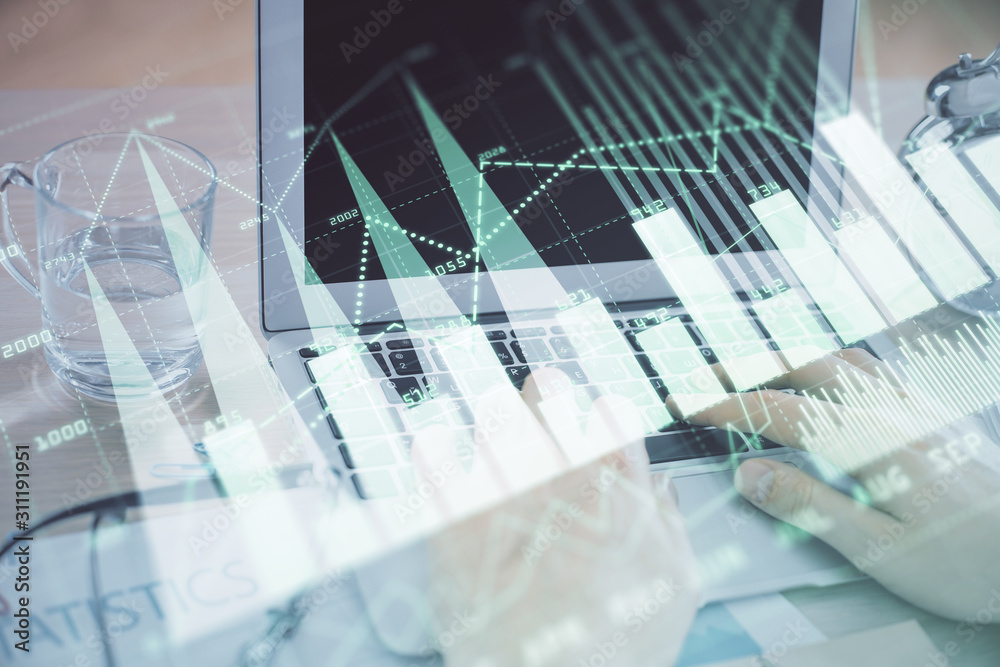Multi exposure of market chart with man working on computer on background. Concept of financial analysis. Multi exposure of market chart with man working on computer on background. Concept of financial analysis.