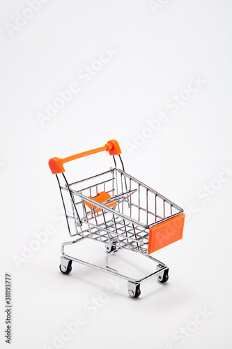 Empty shopping cart trolley on white background with copy space
