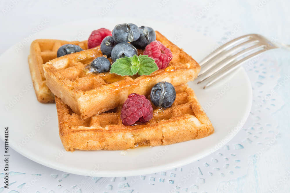 Waffles, raspberries, blueberries and honey Waffles, raspberries, blueberries and honey