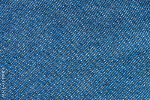 Clean blue jean denim top view close up shot to the detail of fabric. textile material and cotton patter tough and durable garment fashion style. For background or wallpaper with copy space for text.