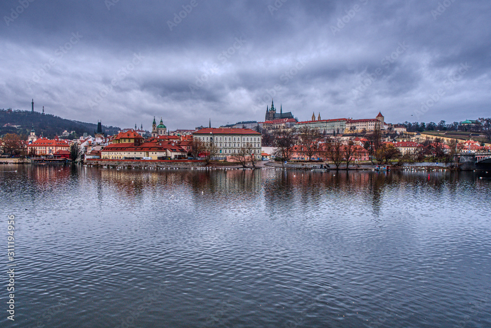 historical part of Prague with castle and cathedral with vltava in foreground