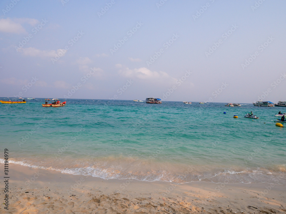 Obraz premium The clear blue sea has a boat in the sea of ​​Koh Lan, Chon Buri, Thailand.