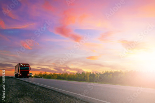 Truck on the highway on the background beautiful sunset © serhio777