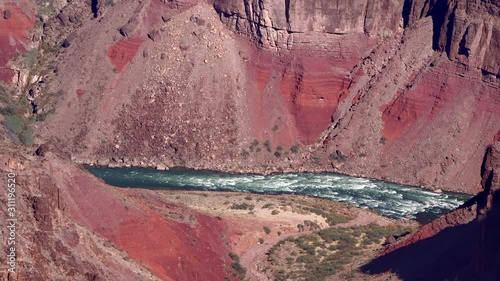 Colorado River rapids weaving and flowing through the Grand Canyon during a bright day photo