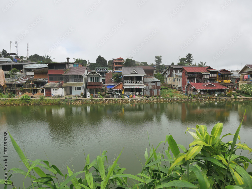 Obraz premium houses on bank of the river