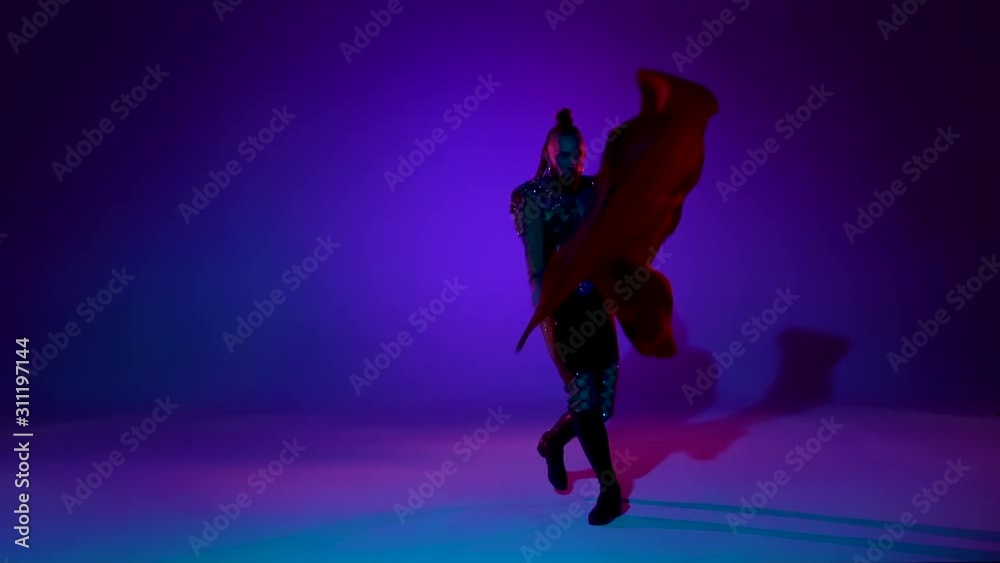 Torero in blue and gold suit or typical spanish bullfighter isolated over on a blue background. Close up, slow motion. Torero in blue and gold suit or typical spanish bullfighter isolated over on a blue background. Close up, slow motion.