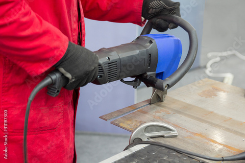 Male cuts metal hydraulic hand tool. Metalworking