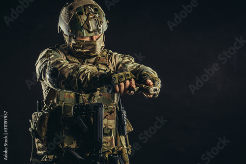 special military service, defense concept. brave strong young man in military uniform stand holding weapon, gun. always on service