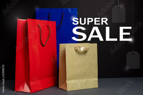 Three color paper Shopping bag isolated on black background. Packaging template mockup. Delivery concept advertising mock. Shopping and sale concept
