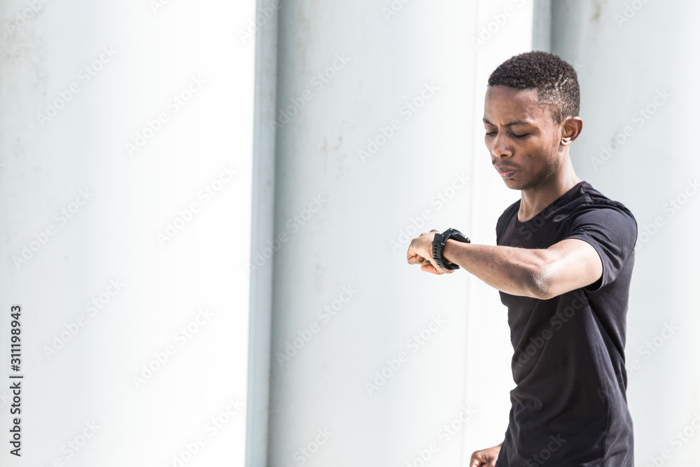 Athletic young afroamerican man running on the promenade. Black Male runner sprinting outdoors. Healthy lifestyle concept.