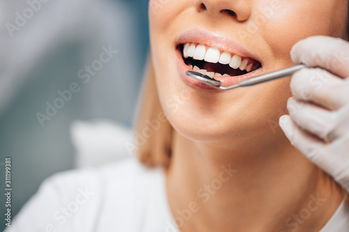 Orthodontic examination of teeth  young woman patient examine teeth while visiting professional doctor. Checkup  teeth examination