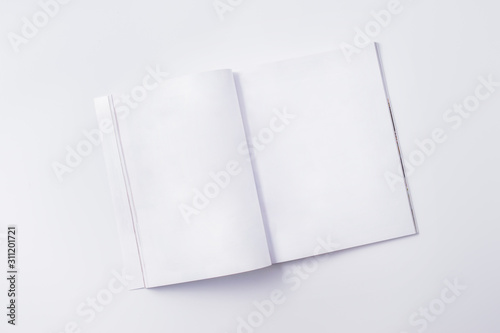 Flat lay mockup with white open magazine on a white background