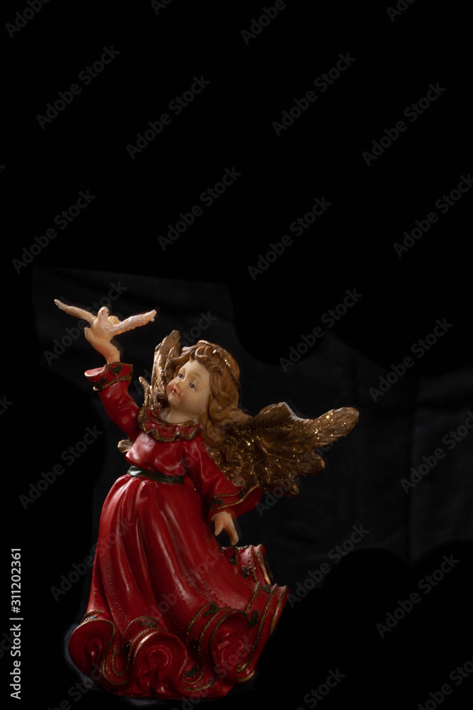 angel in red cloth on black backround
