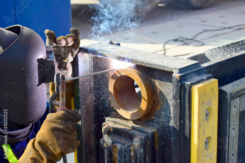 The welder working to welding the bushing of stoplock sluice the dam,December 2019 photo