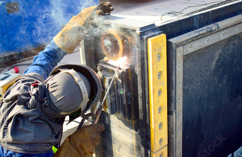 The welder working to welding the bushing of stoplock sluice the dam,December 2019 photo