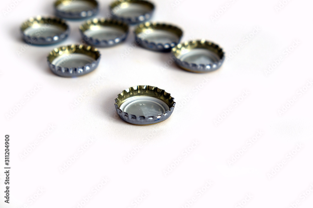 Coke and soda lid on white floor, many soda bottle caps Coke and soda lid on white floor, many soda bottle caps