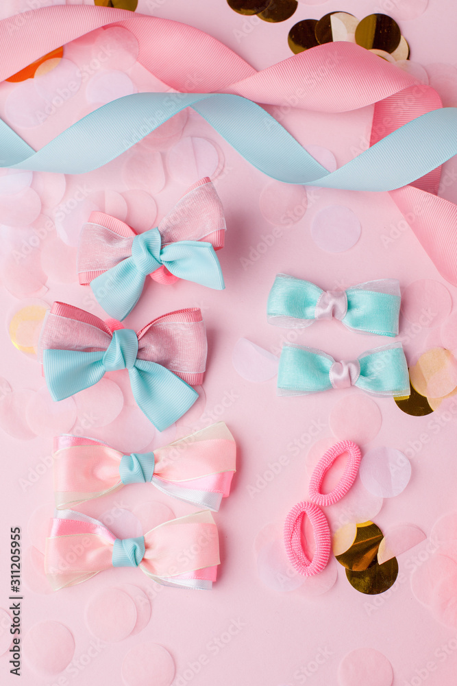 Cute kids hair claws on pink background. Hair clips, hairpins, bow tie for holiday party. Fashion design hair accessories for little girls, decor for hair, childhood concept Cute kids hair claws on pink background. Hair clips, hairpins, bow tie for holiday party. Fashion design hair accessories for little girls, decor for hair, childhood concept